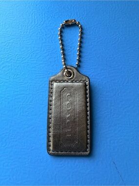 Coach hangtag, metallic pewter color, one sided logo